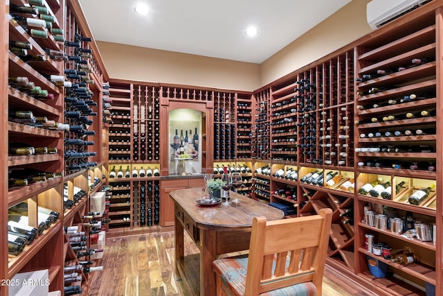 wine area featuring recessed lighting, wood finished floors, and an AC wall unit