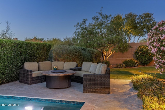 view of patio / terrace featuring a fenced backyard and an outdoor living space with a fire pit