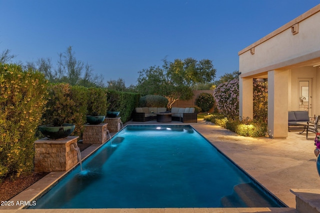 view of pool with outdoor lounge area, a fenced in pool, and a patio area