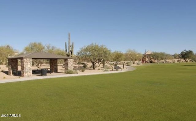 view of home's community with a lawn and a gazebo