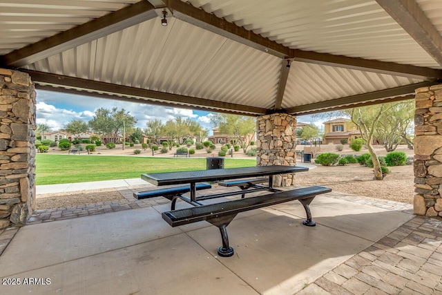 surrounding community with a yard and a patio area