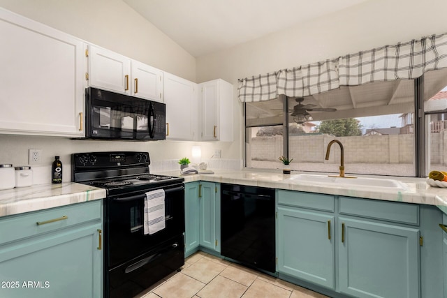 kitchen featuring tile countertops, light tile patterned floors, a sink, black appliances, and white cabinets