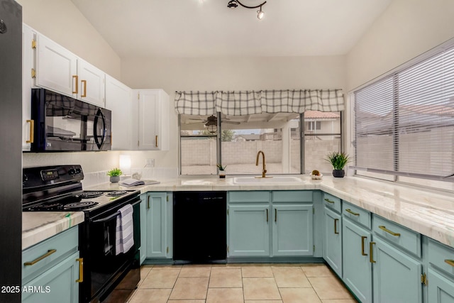 kitchen featuring white cabinets, black appliances, light countertops, and a sink