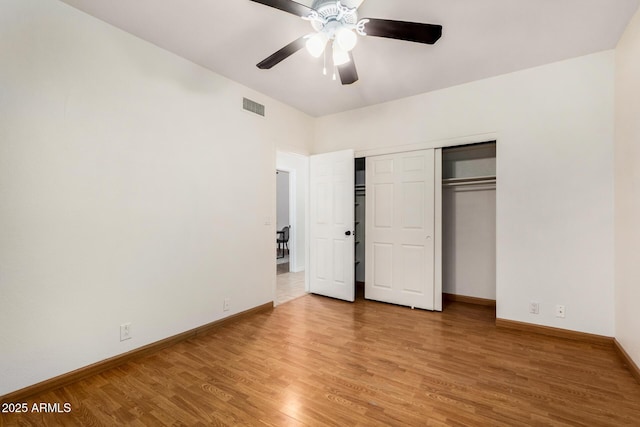 unfurnished bedroom with light wood-style flooring, baseboards, visible vents, and a closet