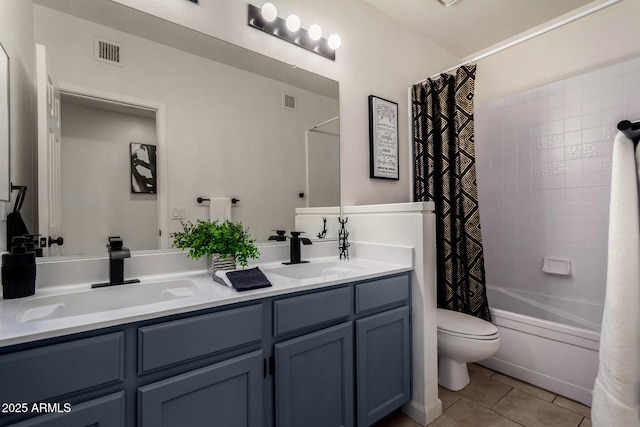 full bath featuring a sink, visible vents, double vanity, and tile patterned flooring