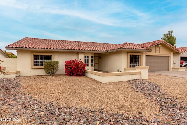 view of front of home featuring stucco siding, a garage, concrete driveway, and a tiled roof