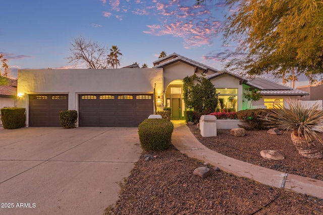 view of front of house featuring a garage and solar panels