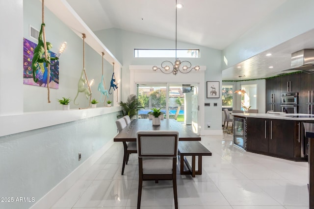 dining room featuring light tile patterned flooring, a chandelier, and vaulted ceiling