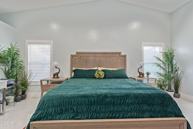 bedroom featuring high vaulted ceiling, light tile patterned flooring, and multiple windows