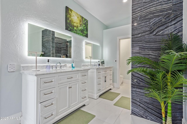 bathroom featuring tile patterned floors, toilet, and vanity