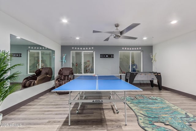 game room featuring light wood-type flooring and ceiling fan