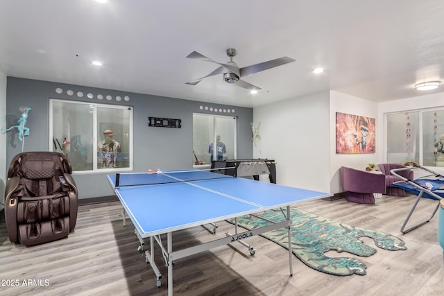 game room with ceiling fan and light wood-type flooring