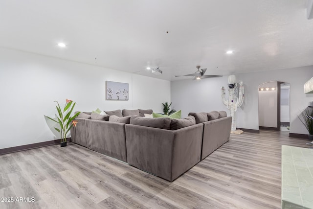 living room with ceiling fan and light hardwood / wood-style floors