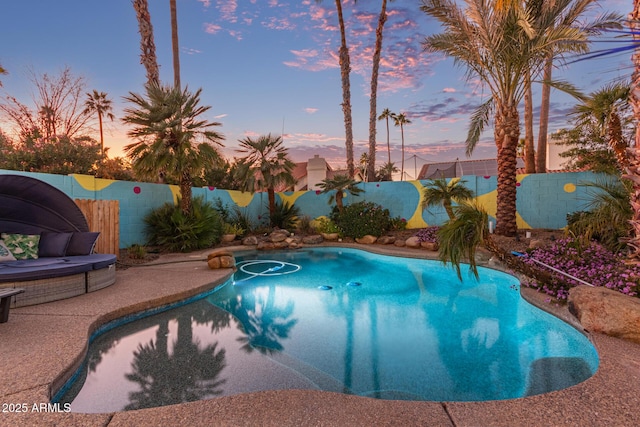 view of pool at dusk