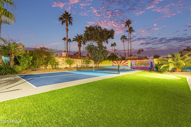 exterior space with tennis court and a yard