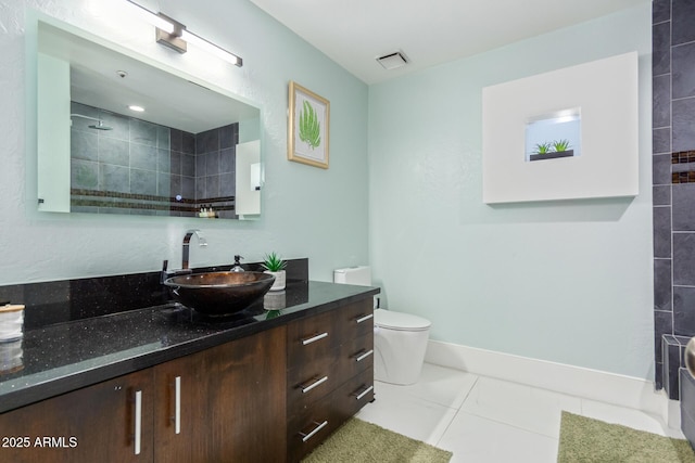 bathroom featuring tile patterned floors, vanity, and toilet