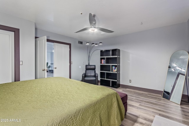 bedroom with ceiling fan and hardwood / wood-style floors