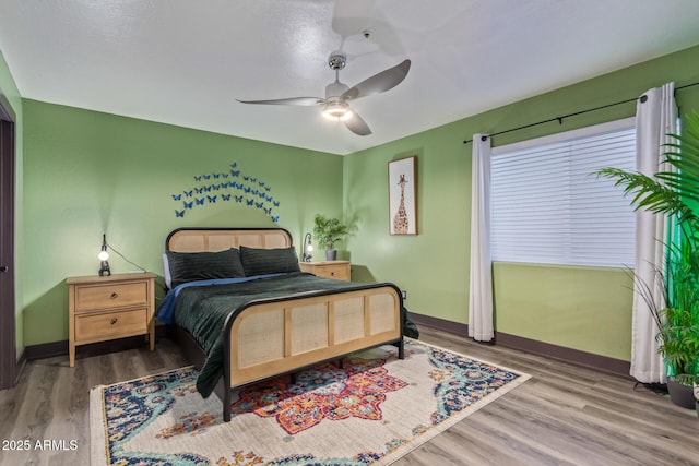 bedroom featuring ceiling fan and hardwood / wood-style flooring