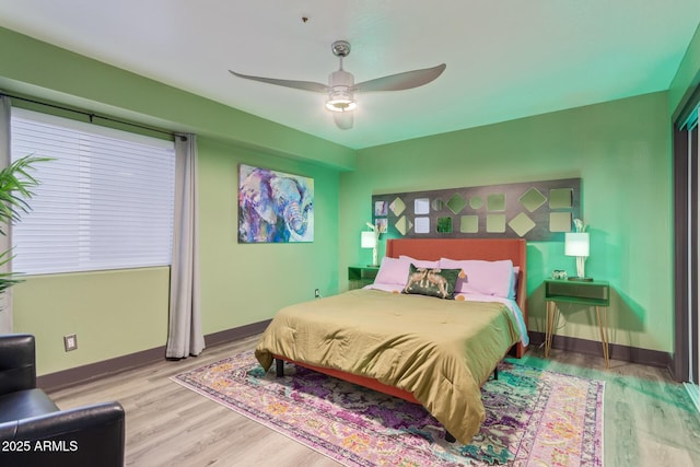 bedroom with ceiling fan and light hardwood / wood-style flooring