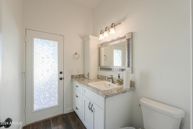 bathroom featuring vanity, toilet, and hardwood / wood-style floors