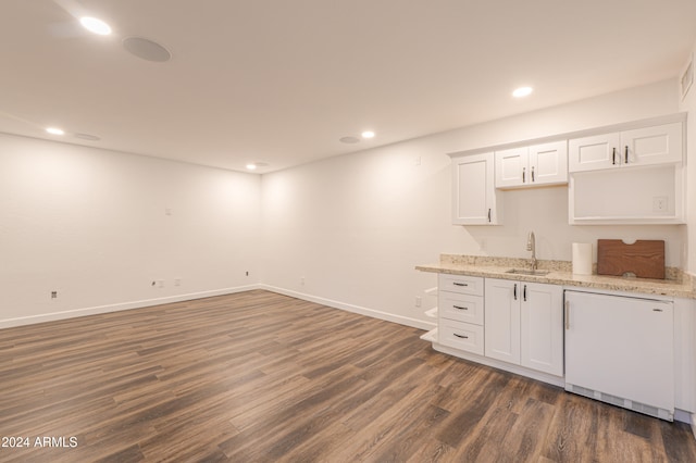 kitchen featuring light stone countertops, sink, dishwasher, white cabinetry, and dark hardwood / wood-style floors