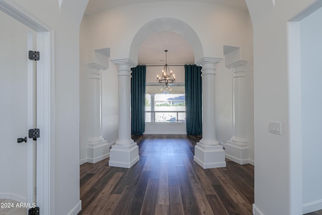 hallway featuring an inviting chandelier and dark wood-type flooring