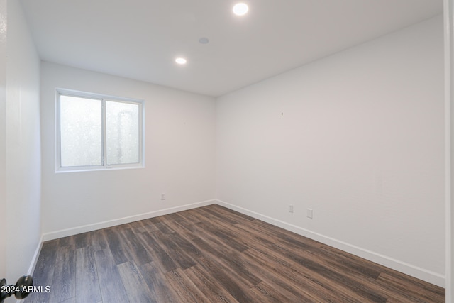 spare room featuring dark hardwood / wood-style flooring