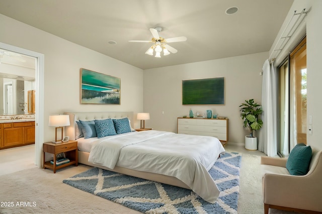 carpeted bedroom with ceiling fan and ensuite bathroom