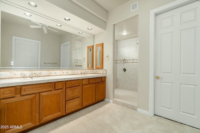 bathroom featuring ceiling fan, tiled shower, vanity, and tasteful backsplash