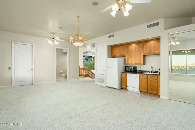 kitchen featuring pendant lighting, white appliances, sink, ceiling fan, and light colored carpet