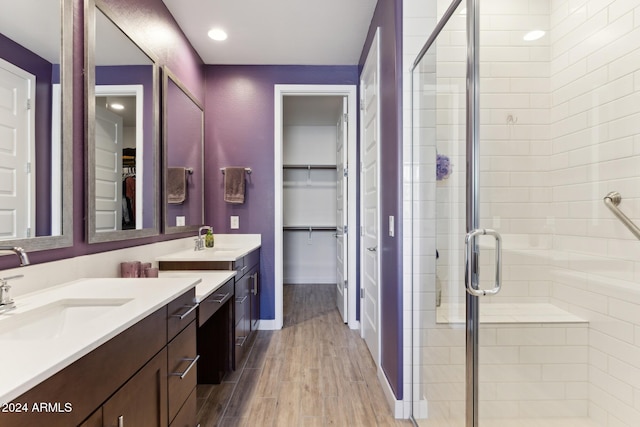 bathroom featuring a shower with door, vanity, and hardwood / wood-style floors