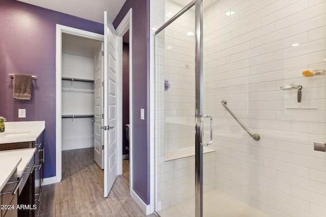 bathroom featuring vanity and a shower with door