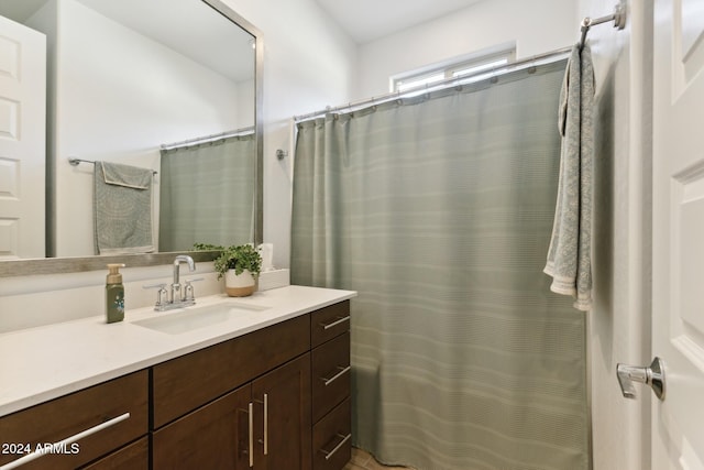 bathroom featuring vanity and curtained shower