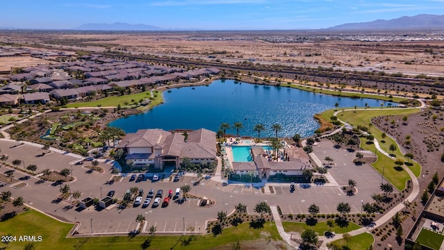 birds eye view of property with a water and mountain view