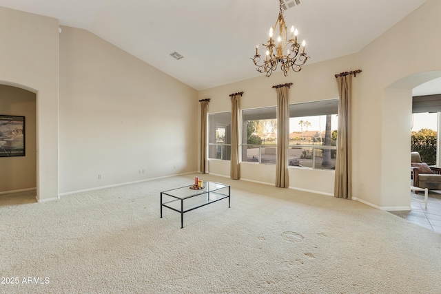 unfurnished living room with light colored carpet, an inviting chandelier, and lofted ceiling