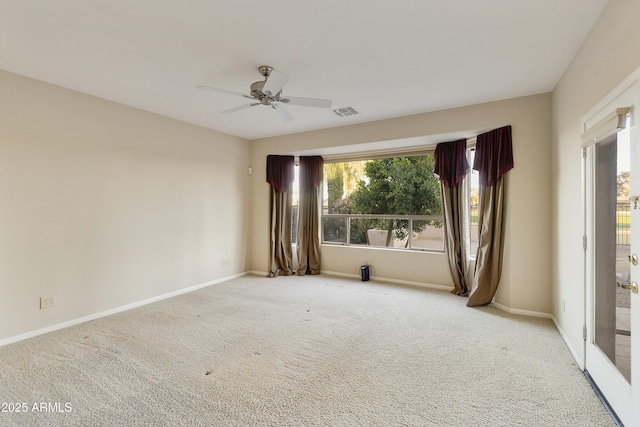 carpeted spare room with ceiling fan