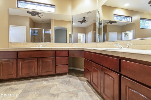 bathroom featuring vanity and an enclosed shower