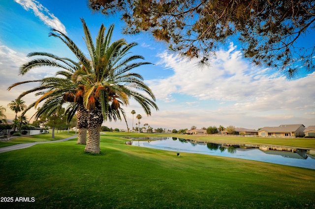 view of home's community with a lawn and a water view