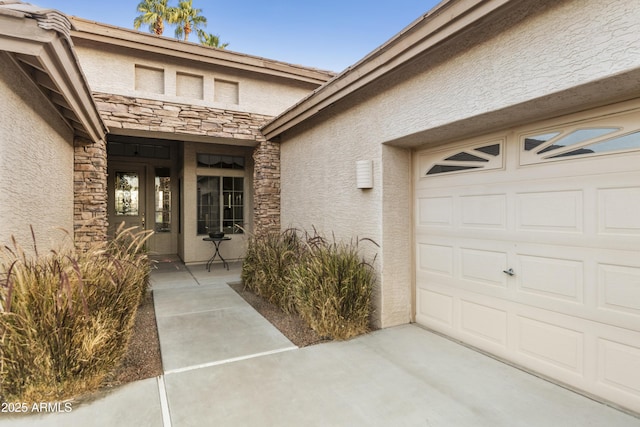 doorway to property with a garage