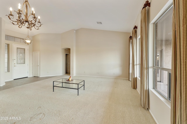 unfurnished living room with carpet flooring and a chandelier