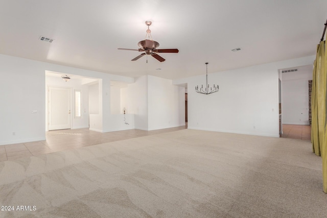 unfurnished room featuring light carpet and ceiling fan with notable chandelier