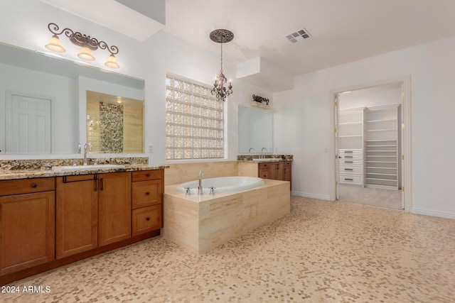 bathroom with a notable chandelier, plus walk in shower, and vanity