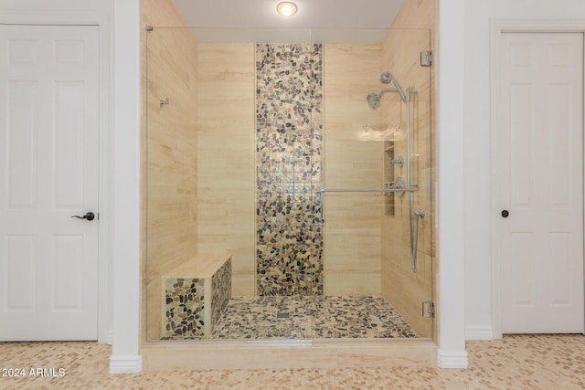 bathroom with tile patterned flooring and walk in shower