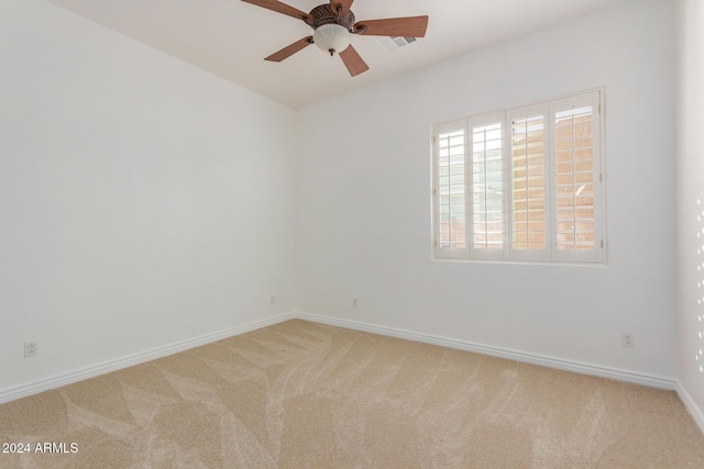 empty room featuring carpet flooring and ceiling fan