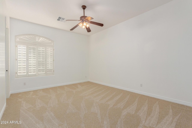 unfurnished room featuring ceiling fan and light carpet