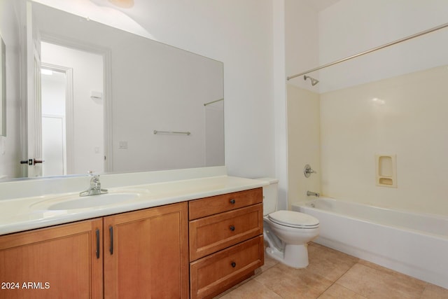 full bathroom featuring tile patterned floors, vanity, toilet, and washtub / shower combination