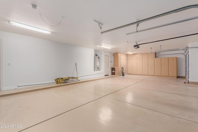 garage with gas water heater and a garage door opener