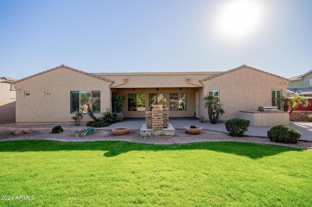 back of house featuring a yard and a patio