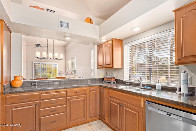 kitchen featuring pendant lighting, sink, ceiling fan with notable chandelier, light tile patterned floors, and stainless steel dishwasher