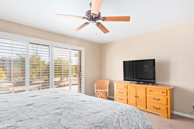 bedroom featuring light colored carpet, access to exterior, and ceiling fan